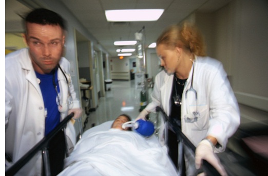 Doctors Rushing Patient down Hall