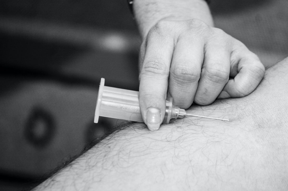 Syringe going into arm