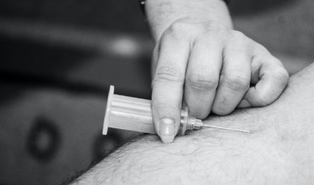 Syringe going into arm