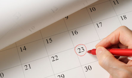 A person uses a red pen to circle the 23rd on a calendar, representing the end of the statute of limitations for personal injury.