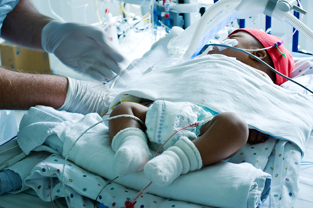 Nurse Caring for Baby After NICU Malpractice