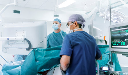 Two Doctors Checking Work on Patient to Avoid Surgical Errors
