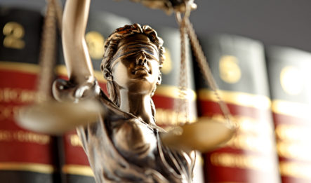 close up image of the bronze legal lady of justice trophy